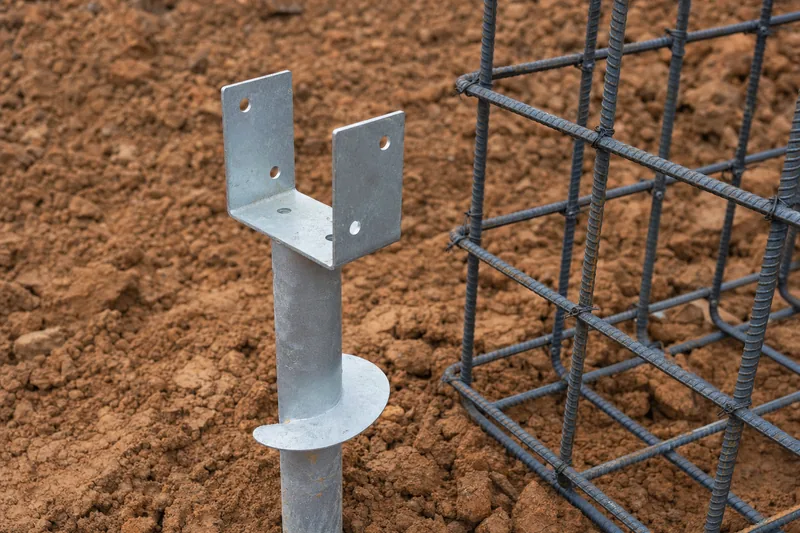Galvanised screw pier head with reinforcement cage in exposed clay, illustrative example